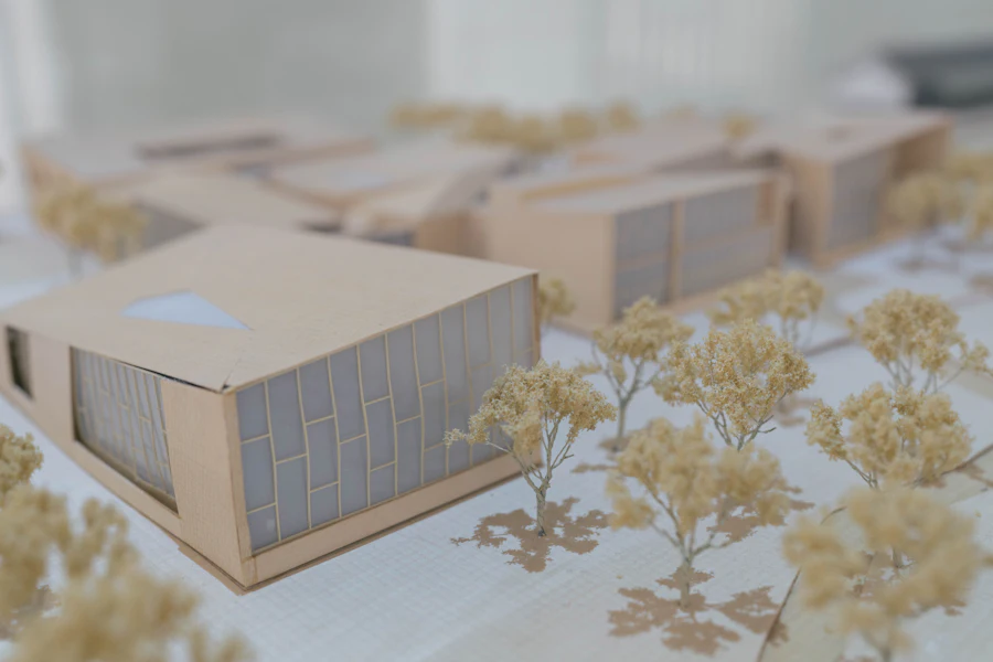 Architectural massing model in timber and card laid out on a studio table