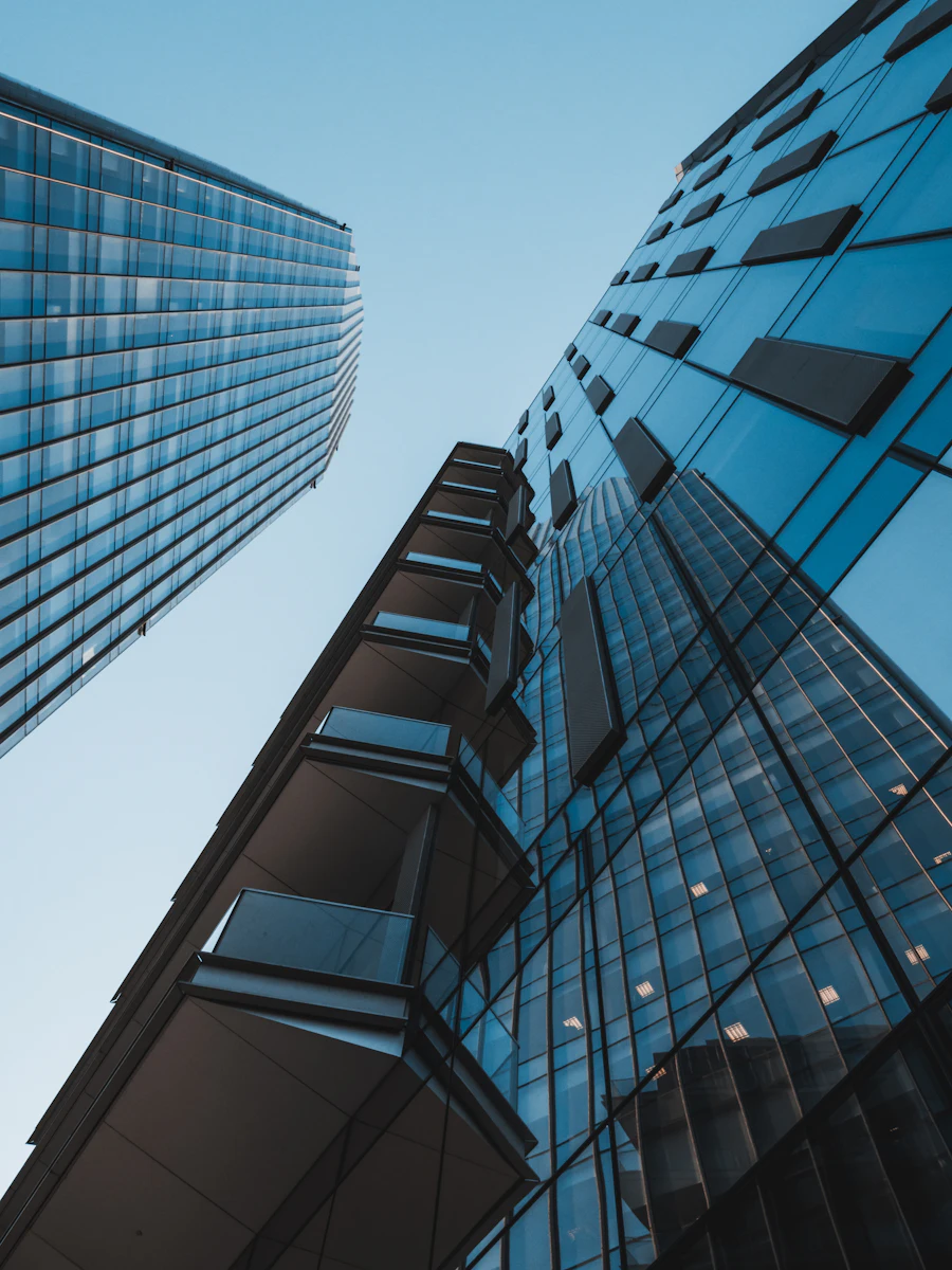 Dark glass office tower rising into the sky
