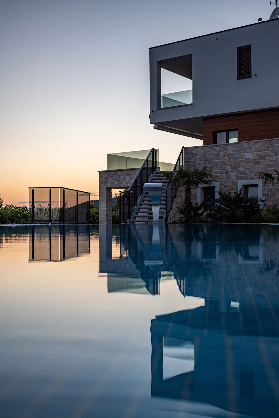 Finished modern house at dusk reflected in a still pool