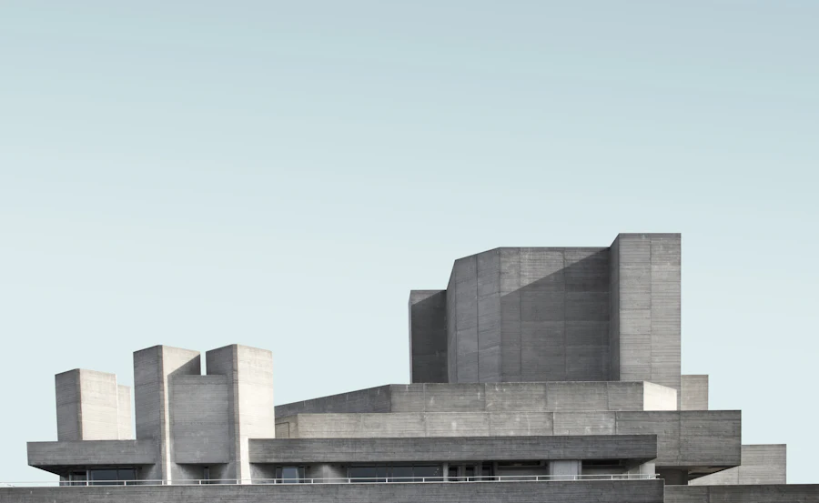 Brutalist concrete civic building with stepped towers against a pale sky