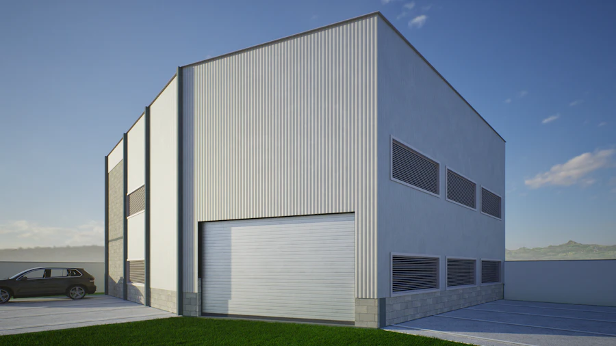 White pre-engineered industrial building with tall loading doors under a clear blue sky