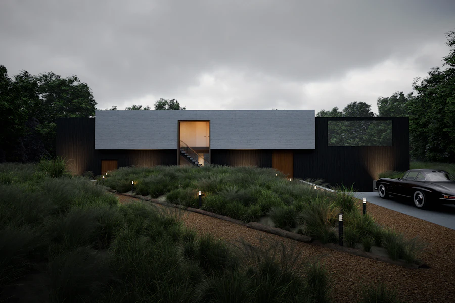 Low dark modern house set into a planted landscape beneath a grey sky